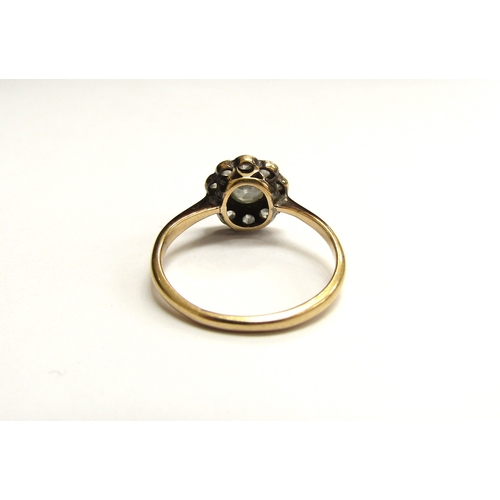 9299 - A diamond daisy ring, 10mm diameter, marks rubbed. Size K, 2g