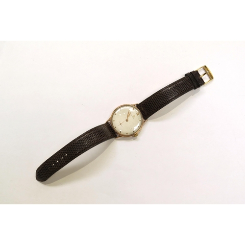 8162 - A 9ct gold omega wristwach on leather strap