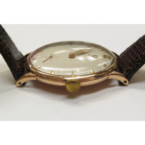 8162 - A 9ct gold omega wristwach on leather strap