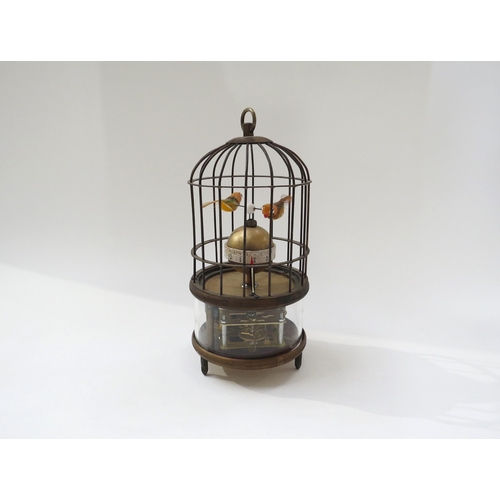 8094 - An automation bird cage clock encasing two birds above a spherical Arabic 12 hour dial, visible move... 