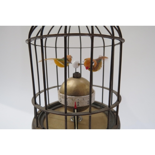 8094 - An automation bird cage clock encasing two birds above a spherical Arabic 12 hour dial, visible move... 