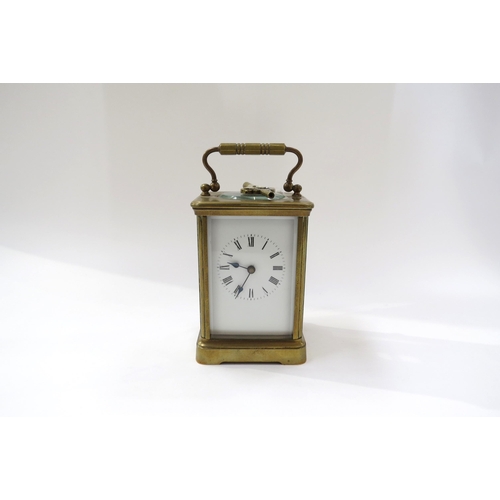 8096 - A 20th Century French brass carriage clock with white face, Roman numerals with key.  13cm tall x 8.... 