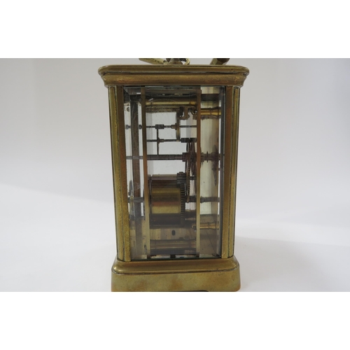 8096 - A 20th Century French brass carriage clock with white face, Roman numerals with key.  13cm tall x 8.... 