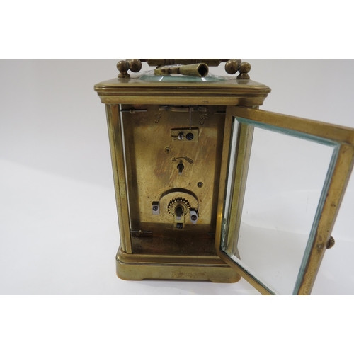 8096 - A 20th Century French brass carriage clock with white face, Roman numerals with key.  13cm tall x 8.... 