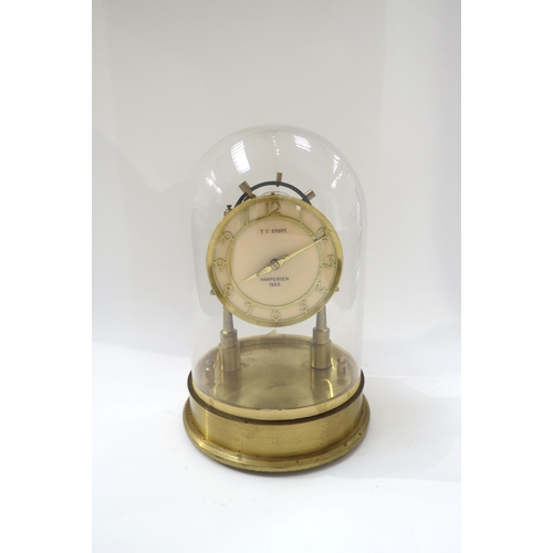 8026 - T C STOTT, Harpenden 1955, solid brass handmade electric clock under glass dome, 29cm tall.