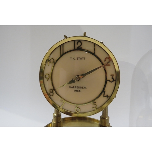 8026 - T C STOTT, Harpenden 1955, solid brass handmade electric clock under glass dome, 29cm tall.