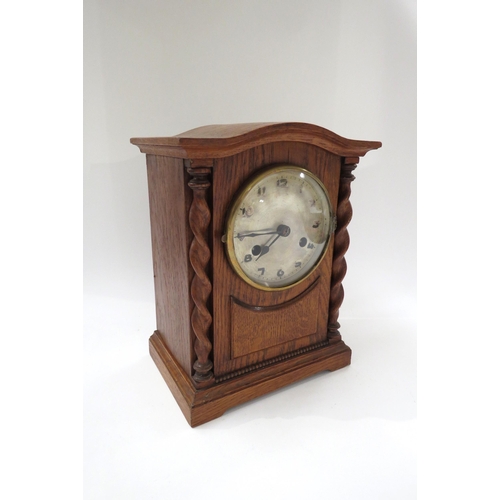 8048 - A German early 20th Century two train mantel clock with Arabic numerals in oak case, striking on a c... 