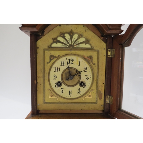 8038 - A German walnut cased architectural form striking mantel clock with Junghans movement, with pendulum... 