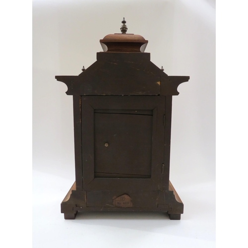 8038 - A German walnut cased architectural form striking mantel clock with Junghans movement, with pendulum... 