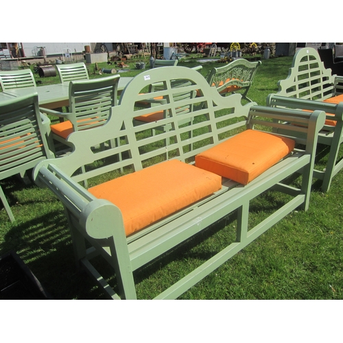 3619 - A green painted teak garden bench with two cushions