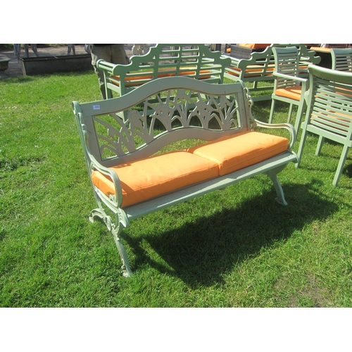 3622 - A cast ended and back green painted garden bench with two cushions