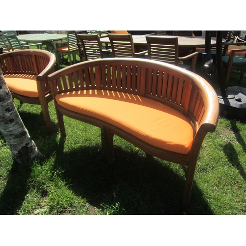 3626 - A curved teak garden bench with cushion