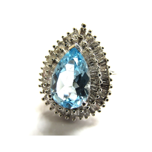 9027 - A 9ct white gold  diamond and topaz cluster ring the central pear shaped blue topaz framed with two ... 