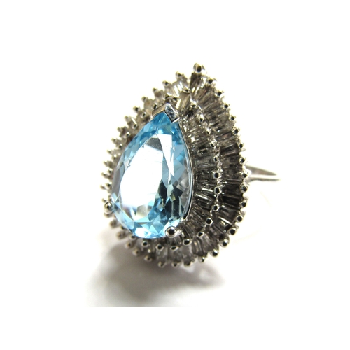 9027 - A 9ct white gold  diamond and topaz cluster ring the central pear shaped blue topaz framed with two ... 