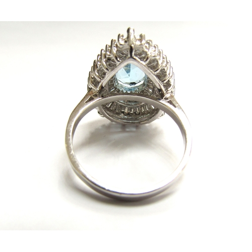 9027 - A 9ct white gold  diamond and topaz cluster ring the central pear shaped blue topaz framed with two ... 