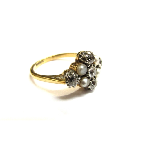 9007 - An 18ct gold platinum set diamond and grey pearl ring, the three vertical diamonds flanked by two gr... 