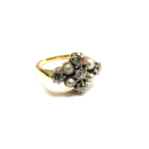 9007 - An 18ct gold platinum set diamond and grey pearl ring, the three vertical diamonds flanked by two gr... 