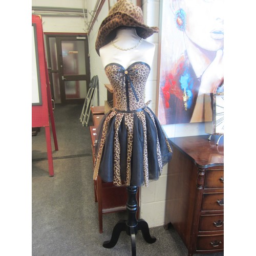 1015 - A full size female mannequin in faux leopard skin costume and similar hat