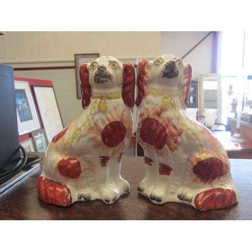 1073 - A pair of Victorian red and white Staffordshire dogs (hairline crack to one) 21.5cm tall  (R)  £30