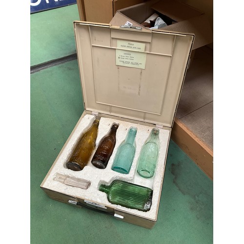 7579 - A case containing six assorted glass bottles including Whitworth Son and Nephew   (C)