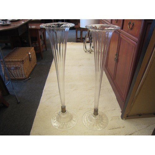 1091 - A pair of late Victorian clear fluted glass vases, 80cms tall, bases 24cm diameter, chip to base of ... 