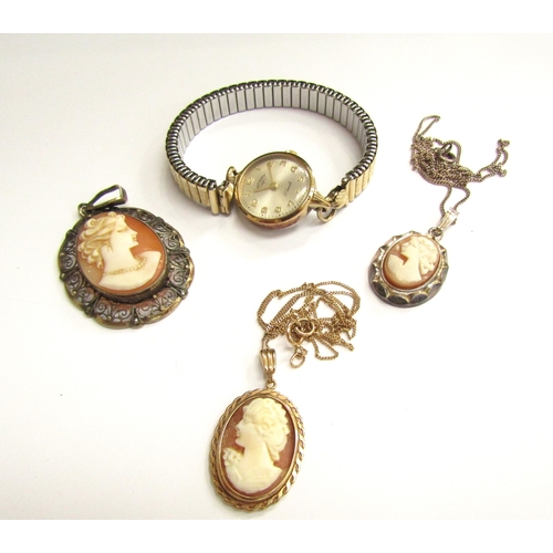 9117 - A gold chain stamped 9k hung with a cameo pendant, a silver example, filigree cameo pendant and a Ro... 