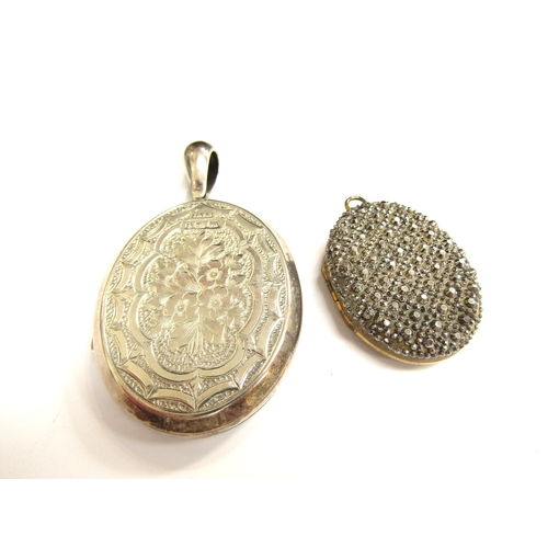 9033 - A Victorian silver oval double photograph locket with image of a stork in rushes to one side and fol... 