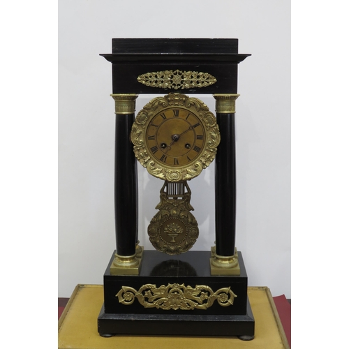 8034 - A late 19th Century Portico four pillar ebonised mantel clock with decoration bezel and pendulum. Cl... 