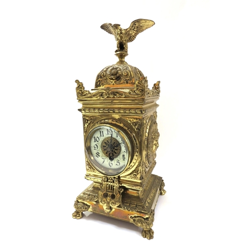 8068 - A French timepiece in highly decorative brass case, Arabic enamelled chapter ring, with pendulum. 42... 