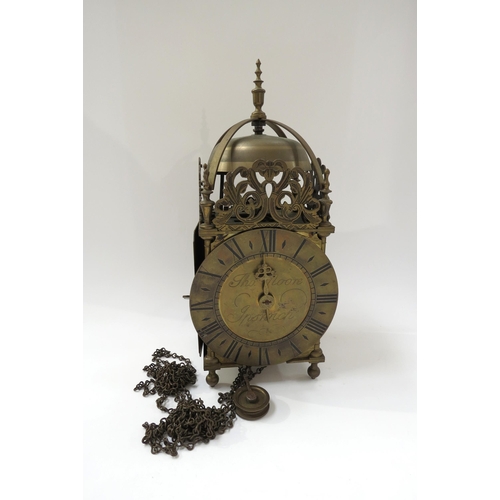 8069 - A lantern clock with single hand and roman silvered dial, signed Thos. Moore. Ipswich. 18th Century ... 