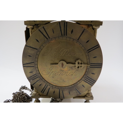 8069 - A lantern clock with single hand and roman silvered dial, signed Thos. Moore. Ipswich. 18th Century ... 