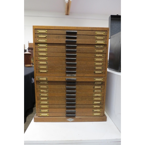 8253 - An oak 20 drawer watch makers cabinet with contents mainly 20th swiss watch parts boxed and labelled... 