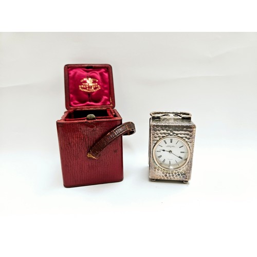 8086 - A Drew & Sons Piccadilly Circus silver miniature carriage clock with red leather travel case and key... 