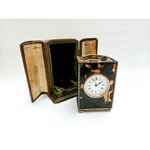 8087 - A Charles & Richard Comyns silver and tortoiseshell miniature carriage clock, with crack to top left... 