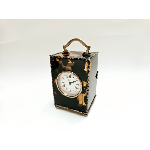 8087 - A Charles & Richard Comyns silver and tortoiseshell miniature carriage clock, with crack to top left... 