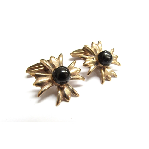 9114 - A pair of 9ct gold cufflinks with cabochon black stone to centre, 9.4g