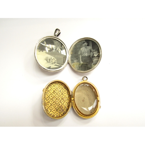 9033 - A Victorian silver oval double photograph locket with image of a stork in rushes to one side and fol... 