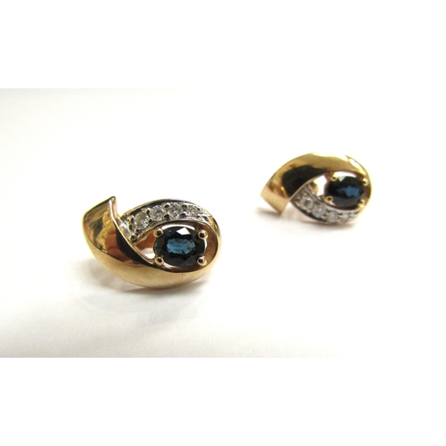 9030 - A pair of 9ct gold sapphire and diamond studs with 14ct gold backs, 2.3g