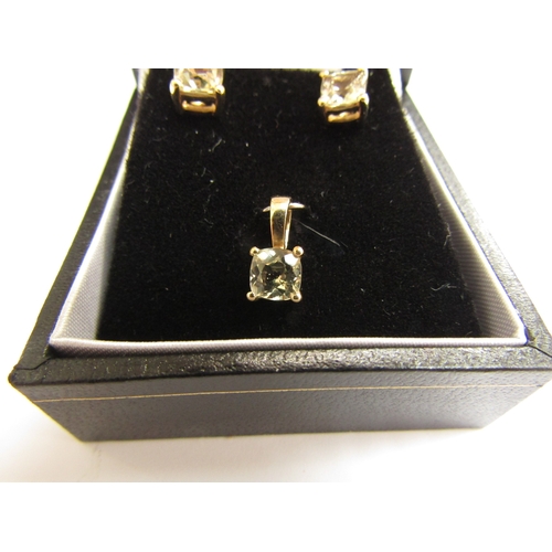 9342 - A pair of 9ct gold csarite stud earrings and a matching pendant, 1.6g               (C)