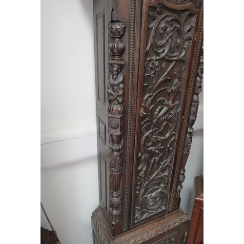 8012 - An 18th Century heavily carved oak longcase clock with silvered Roman chapter ring, date and seconds... 