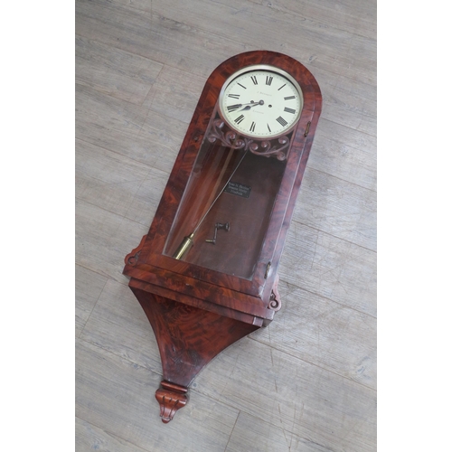 8020 - A mid 19th Century flame mahogany and glazed door wall clock, painted metal Roman dial (10