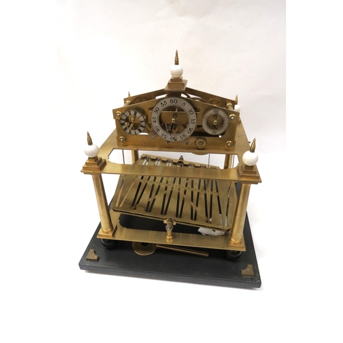 8063 - A Congreve Clock under glass case on stand with key, two steel balls and a single volume 