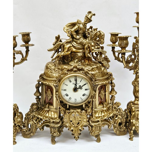 8062 - A 20th Century 'Imperial' brass clock garniture, the clock surmounted by a horseman, flanked by a pa... 