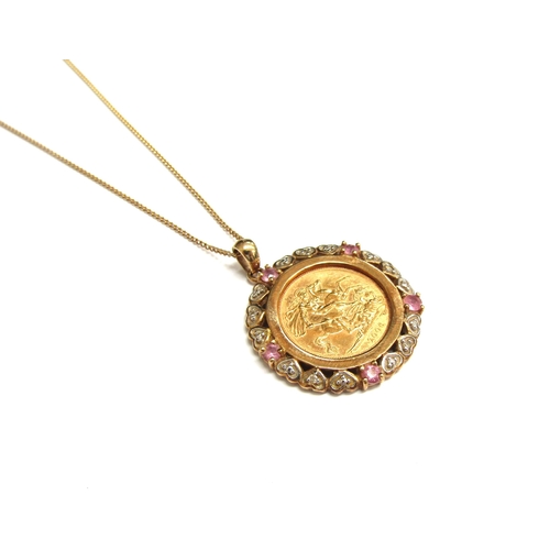 9256 - A 2006 gold half sovereign in a 9ct gold diamond and pink sapphire mount hung on gold chain clasp st... 