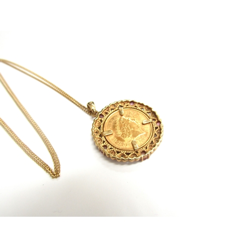 9256 - A 2006 gold half sovereign in a 9ct gold diamond and pink sapphire mount hung on gold chain clasp st... 