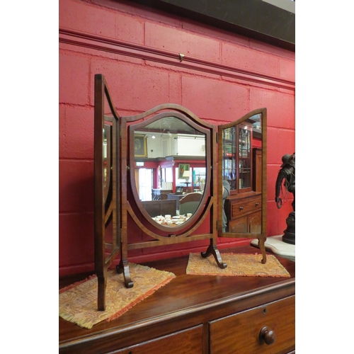 4131 - An Edwardian mahogany shield shape triptych dressing chest mirror on an arched scroll foot base, 71.... 