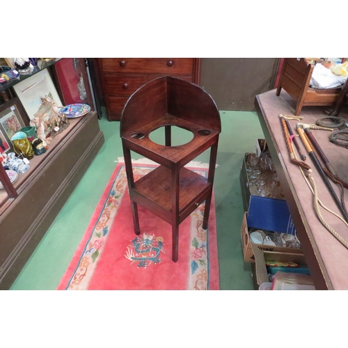 4182 - A George III mahogany two tier gentleman's corner washstand, the raised back over bowl recesses on s... 