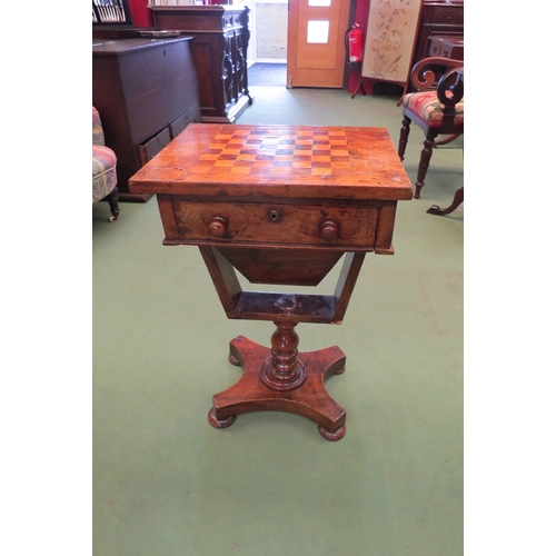 4223 - A Victorian walnut games table, the chequerboard top over a single deep drawer, on turned support to... 