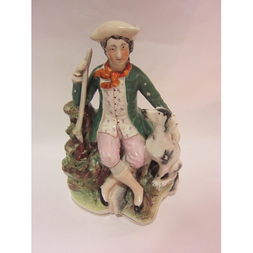 4268 - A Victorian Staffordshire sportsman with dog, 25cm tall, a/f