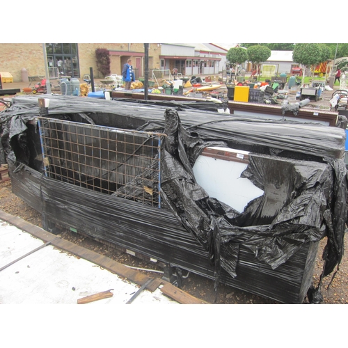 3300 - A metal stillage containing approximately ten unused aluminium glazed wall panels